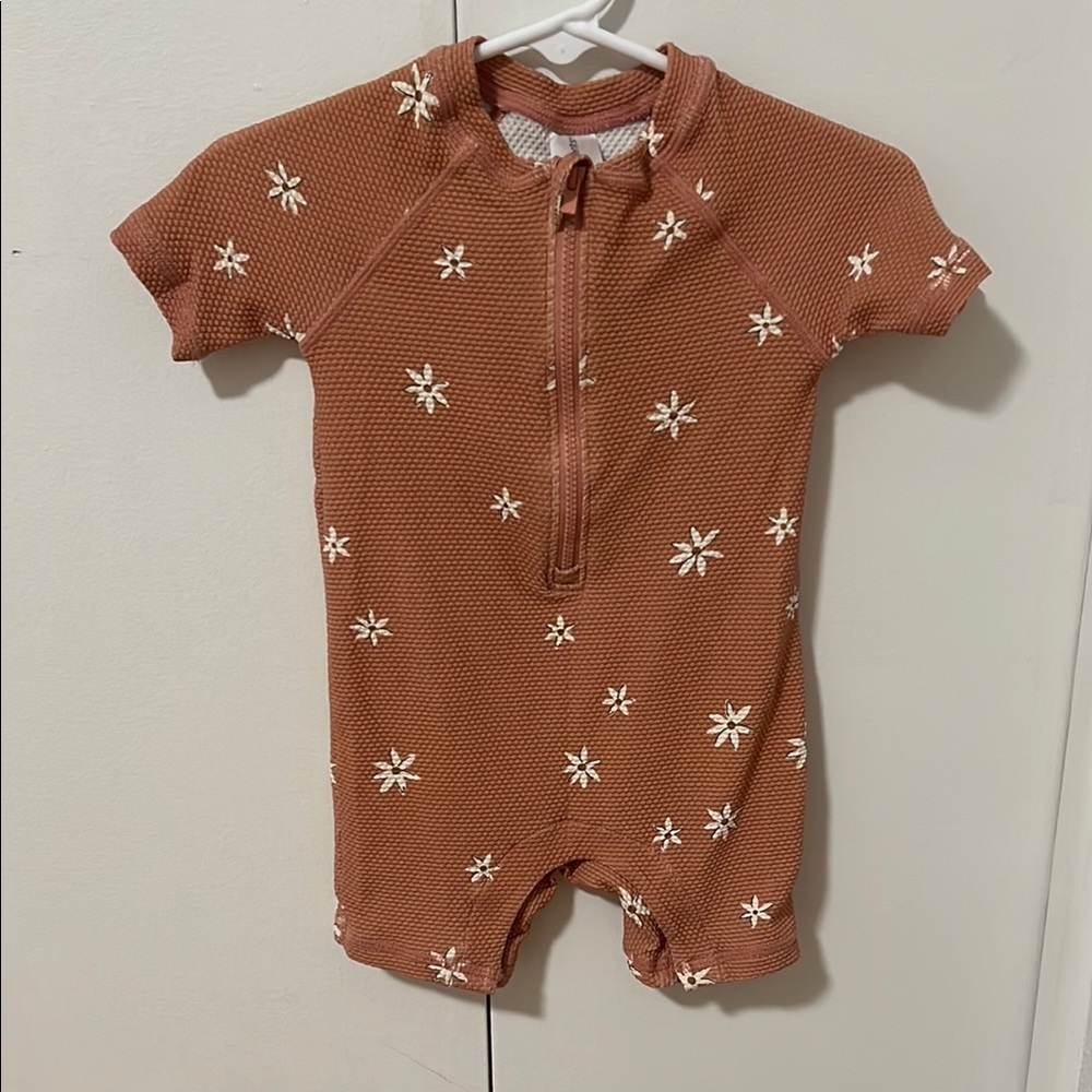 Charming Rust Baby Romper with Floral Accents